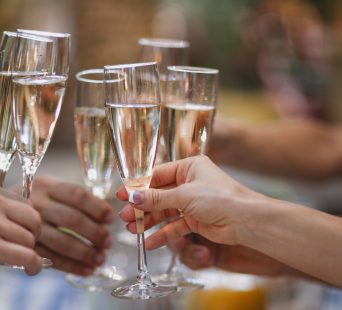 Celebration. People holding glasses of champagne making a toast. Champage with blurred background